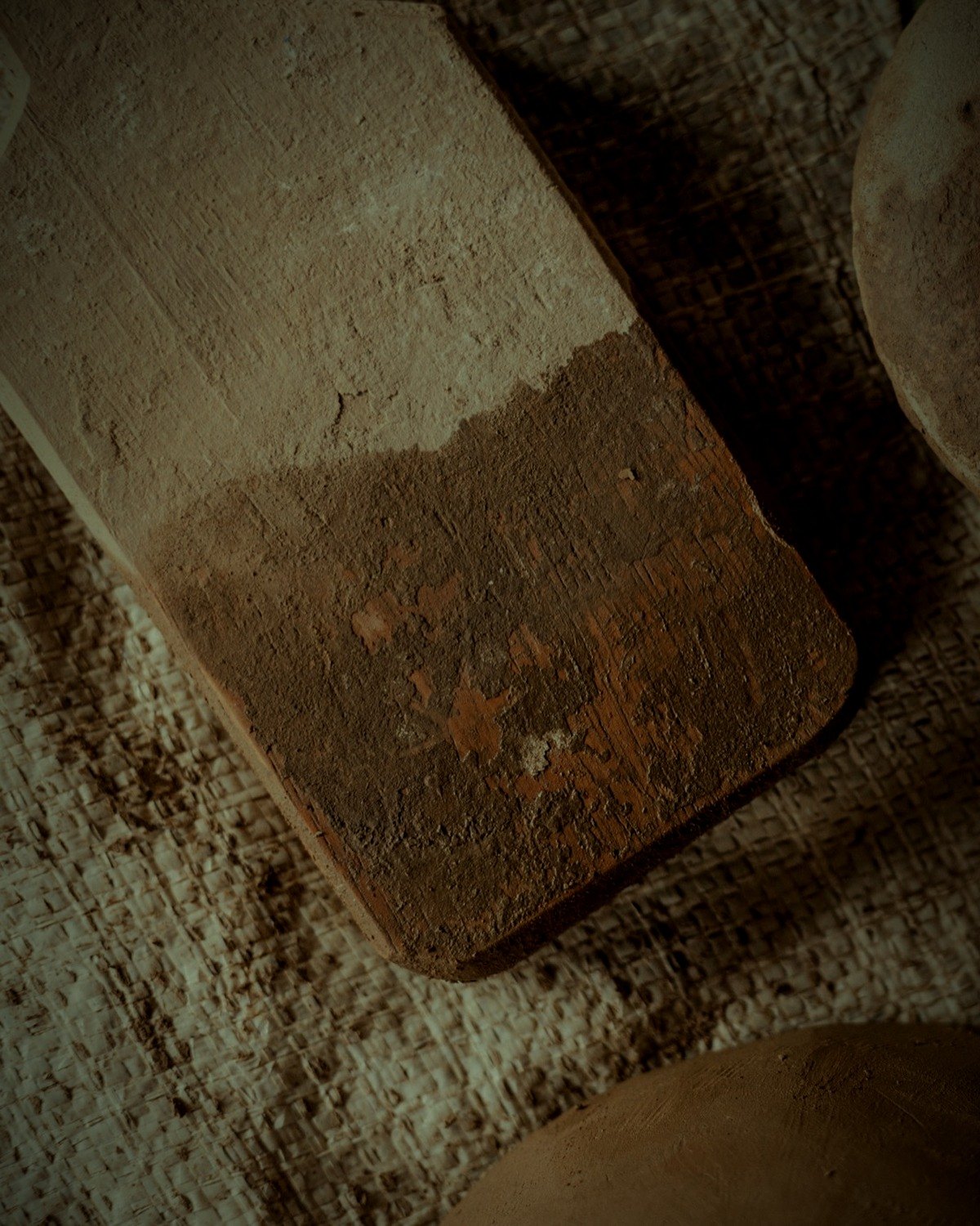 Wooden paddle and river stone on cloth