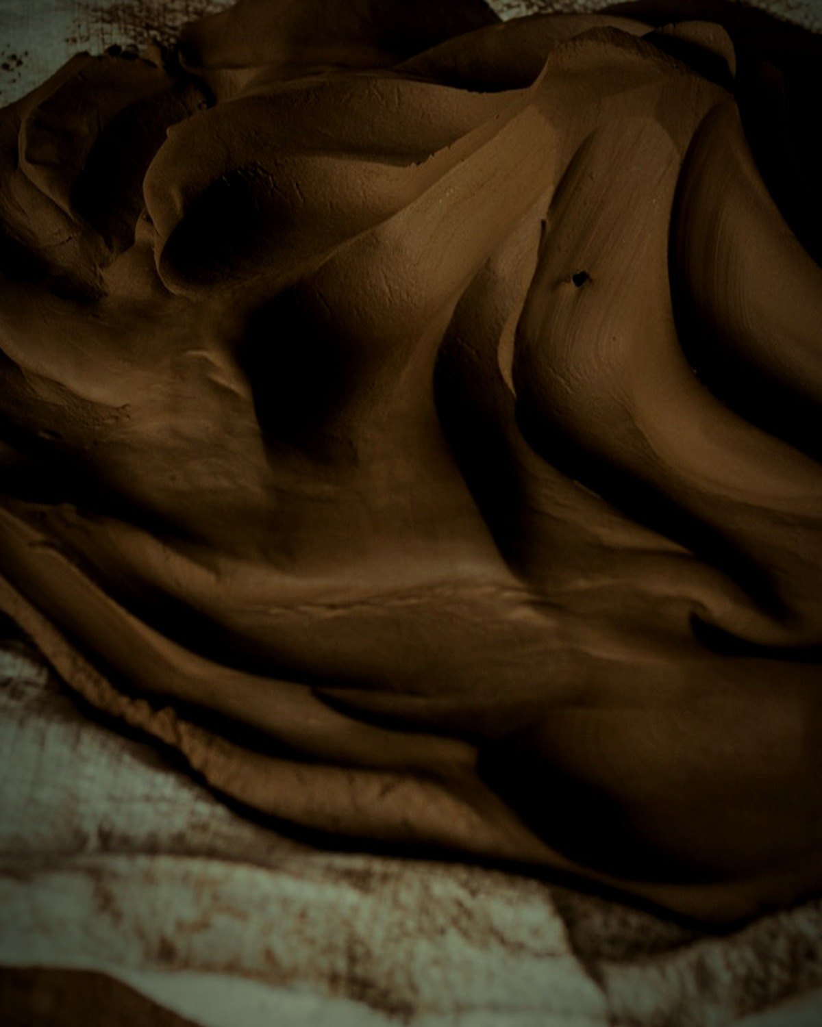 Freshly kneaded clay, worked by foot on a cloth