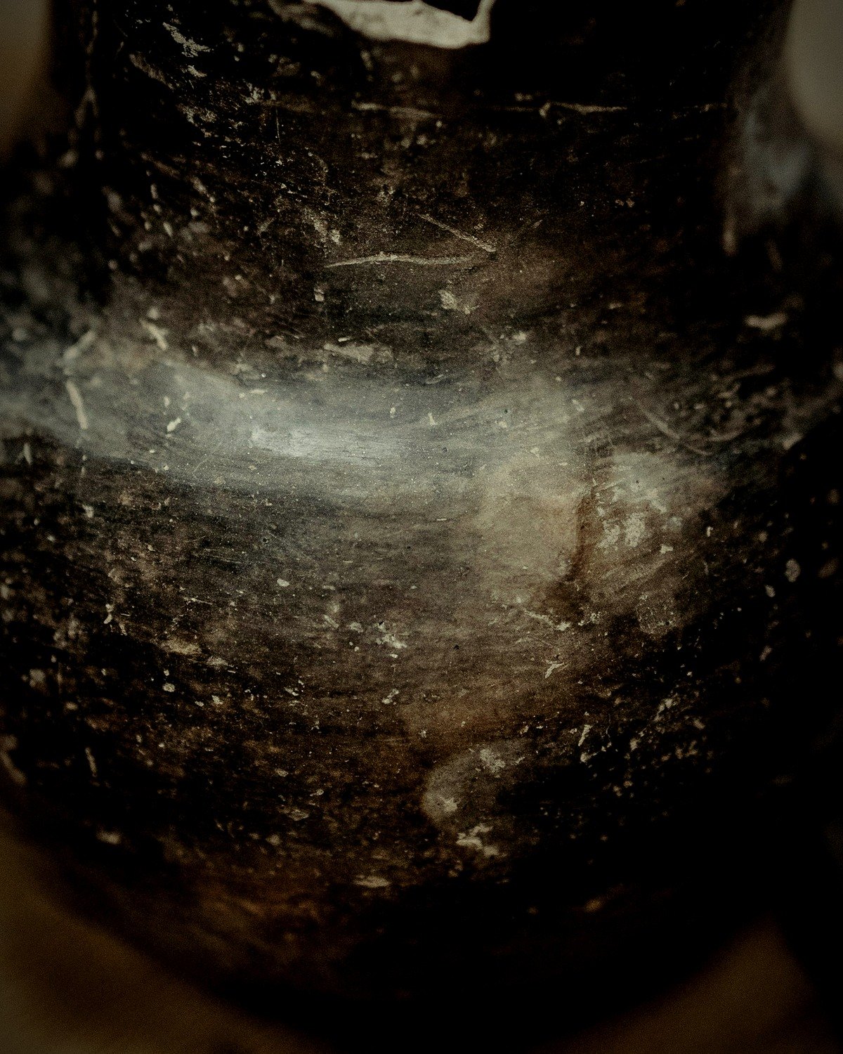 Where the pale surface meets the smoke-black